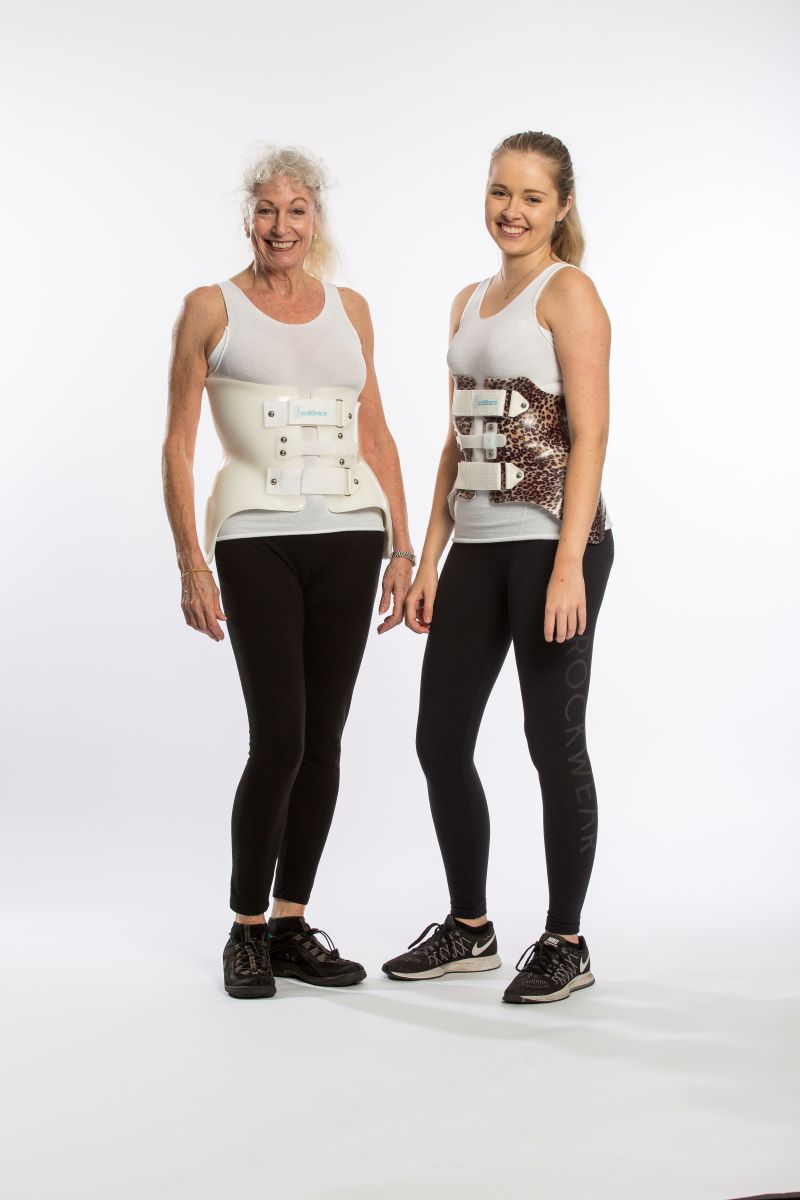 A senior and young adult wear their ScoliBrace for scoliosis treatment in Calgary Alberta at Connected Chiropractic